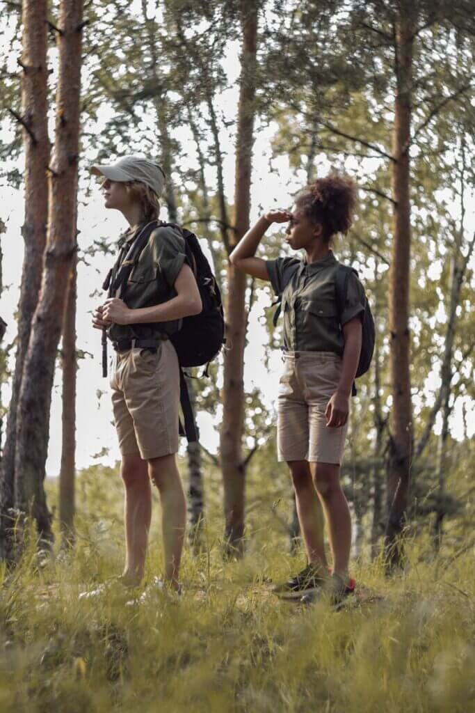 Group of children hiking through a forest, embracing nature and adventure.